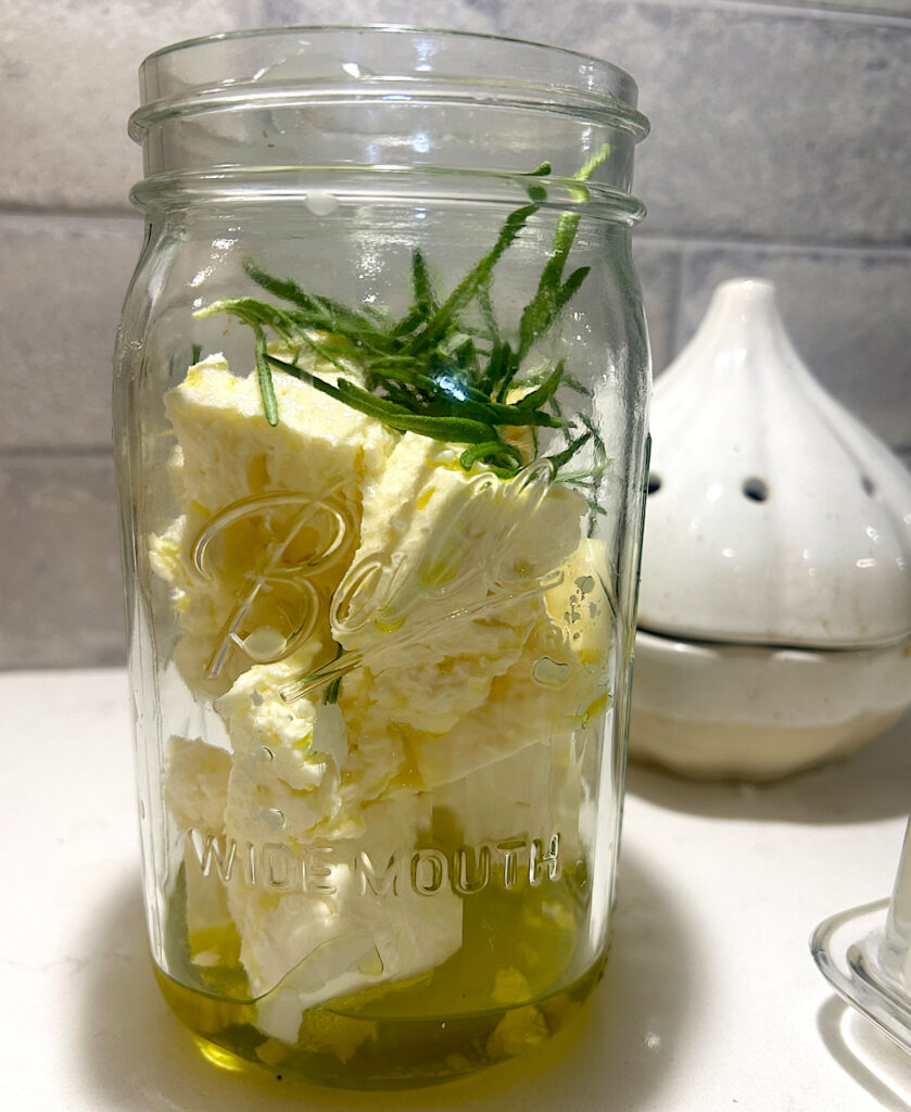 feta, cream cheese, garlic and rosemary in a jar
