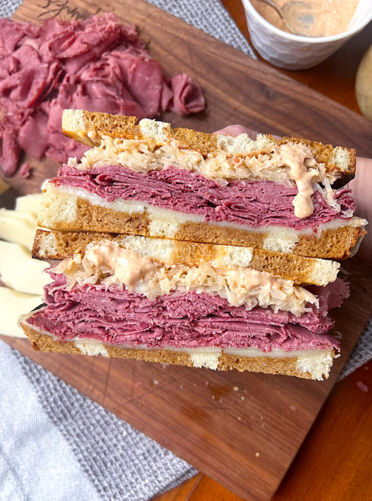 a reuben sandwich with homemade pastrami cut in half