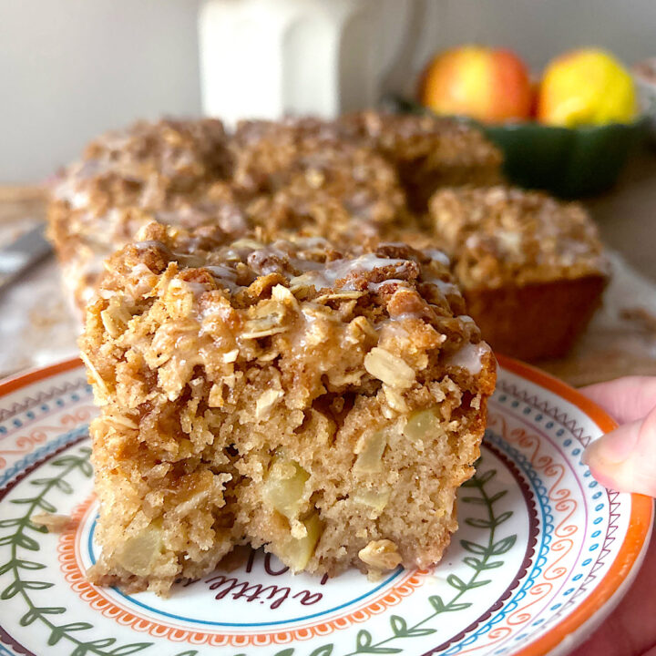 a slice of apple coffee cake on a colorful plate