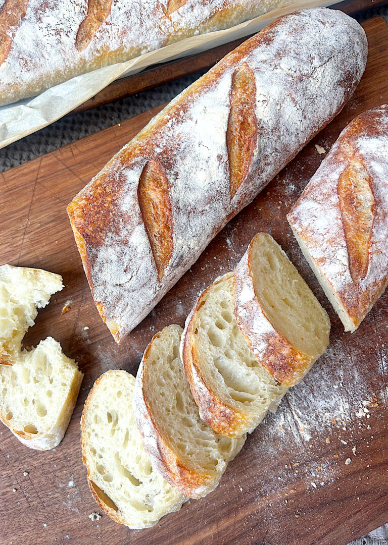 sliced baguette bread on a wood board