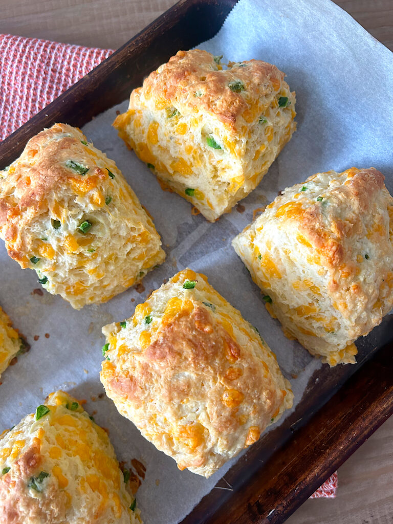 jalepeno and cheddar biscuits on a baking sheet