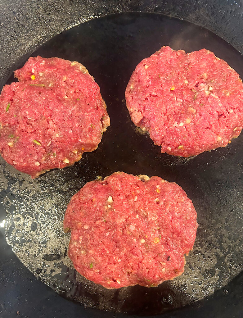 sausage patties in a cast iron skillet