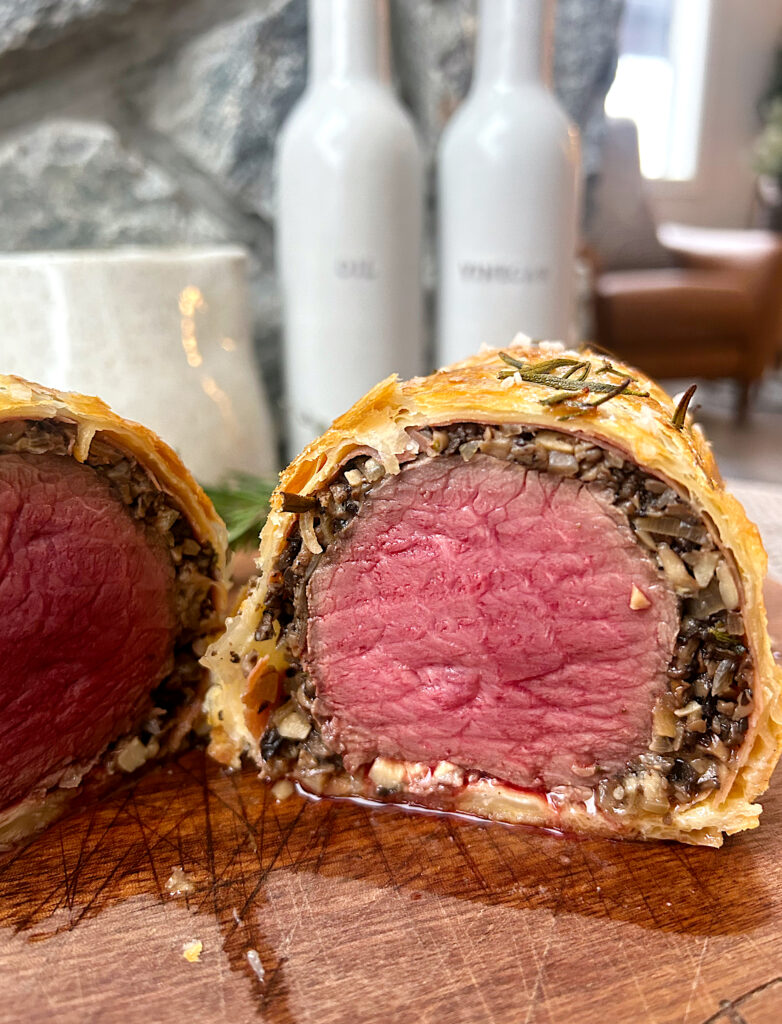 a wellington sliced in half with medium rare cooked meat