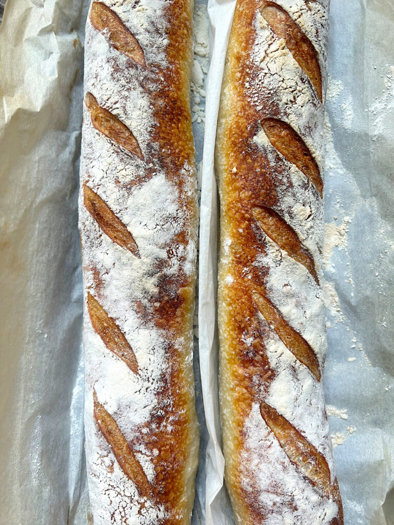 two golden baked sourdough baguettes