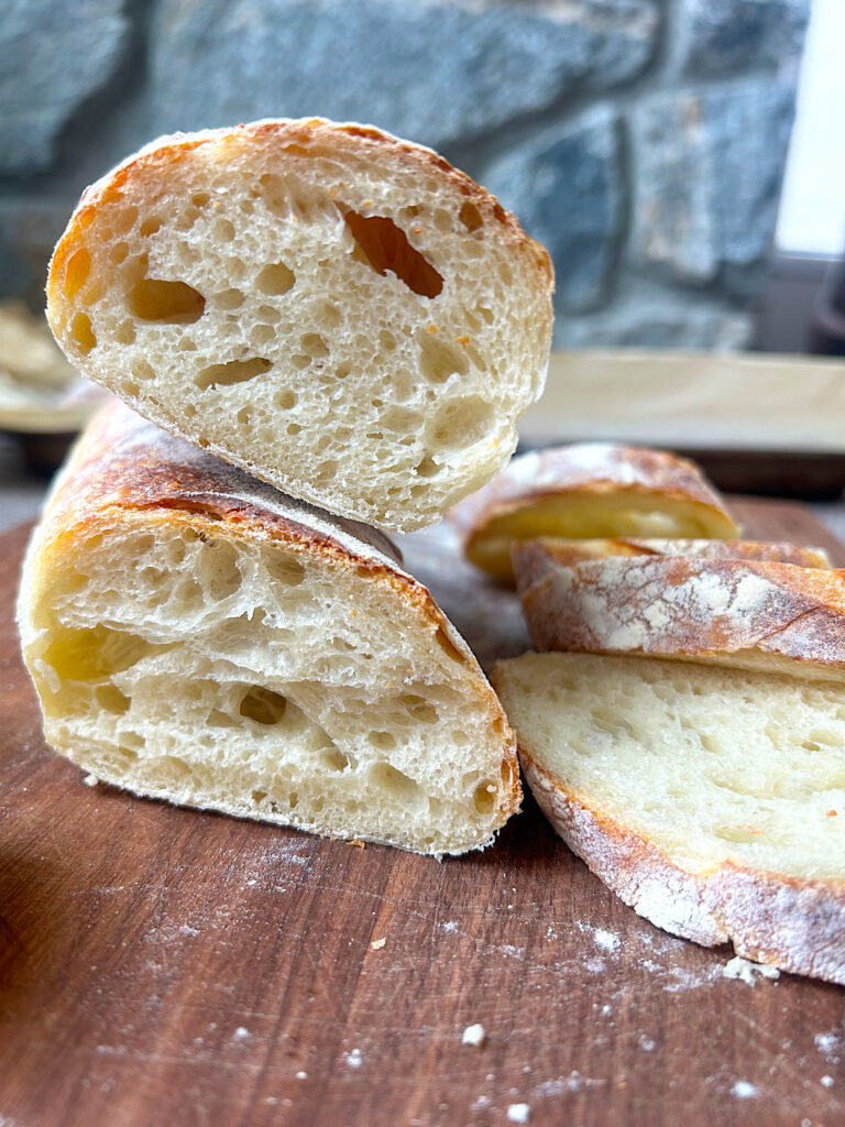a baguettes cut in half on a wood board
