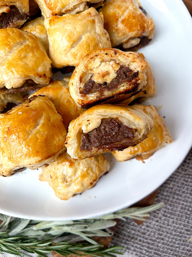 a white plate full of mini venison sausage rolls