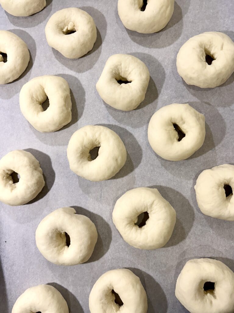 mini unbaked bagels on a baking sheet