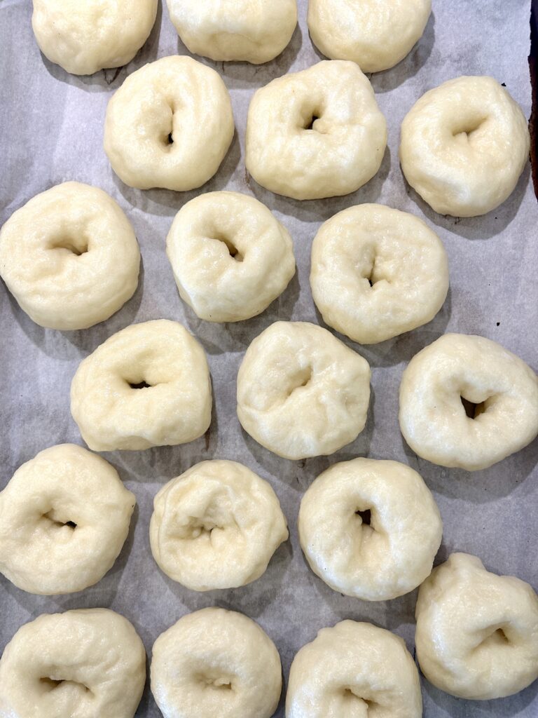 boiled, mini bagels on a baking sheet