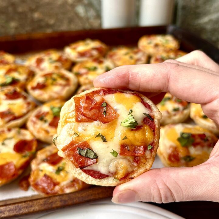 a mini bagel topped with cheese and pepperoni