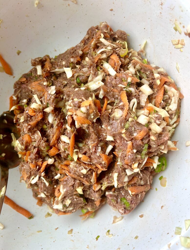 a mixture of ground meat, cabbage and carrots