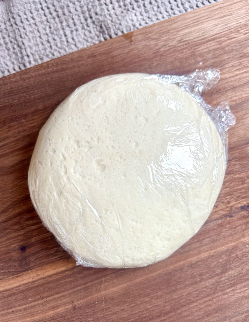 a ball of wonton dough on a wood board