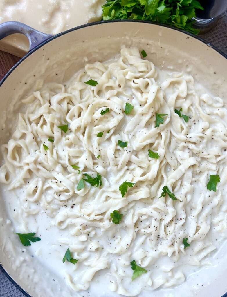 a large skillet full of fettuccine alfredo