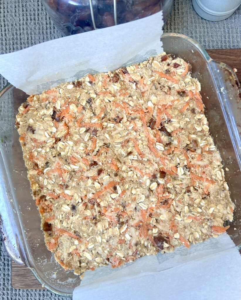 oatmeal bars with carrots and dates in a square baking dish