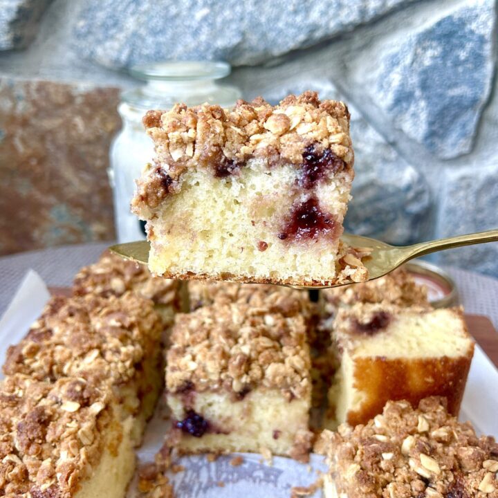 a slice of coffee cake with jam and crumble topping