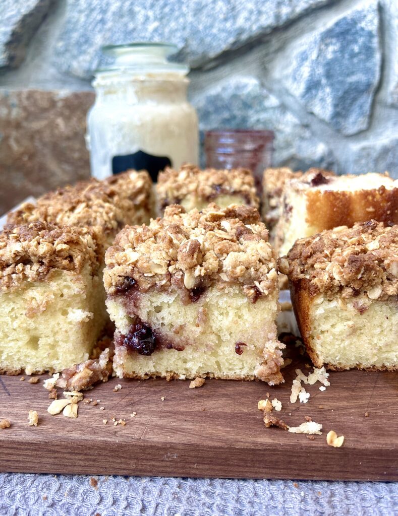 peanut butter and jam coffee cake sliced in into squares on a wood board