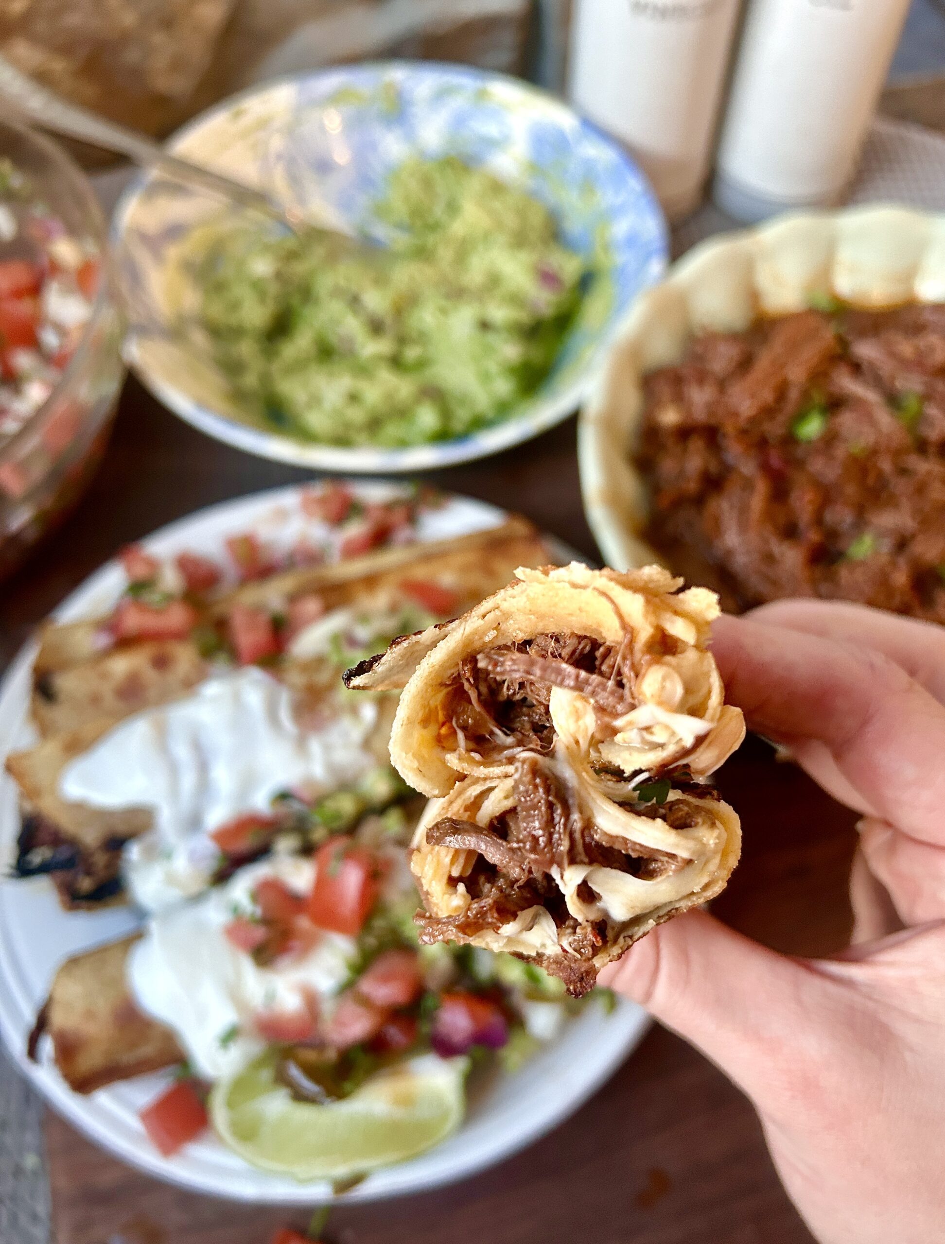 a taquito with meat and cheese ripped in half