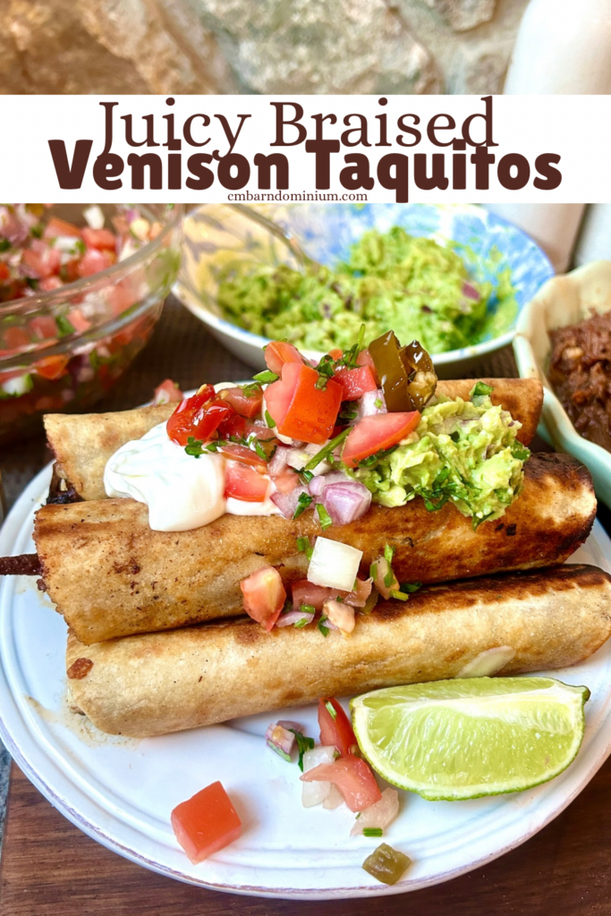 a white plate with taquitos, sour cream and guacamole