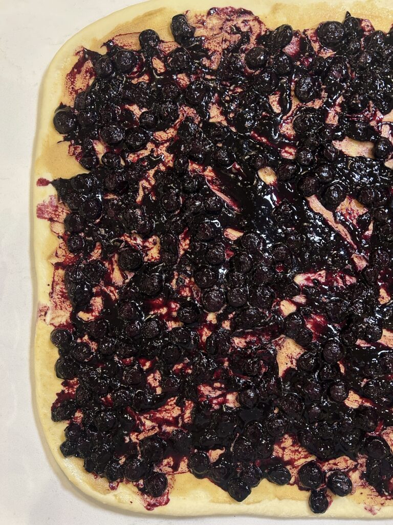 a rectangle of dough with blueberry filling on top