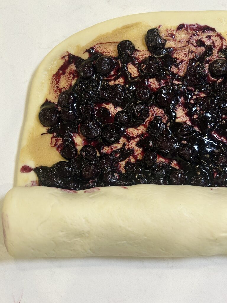 blueberry cinnamon buns being rolled up