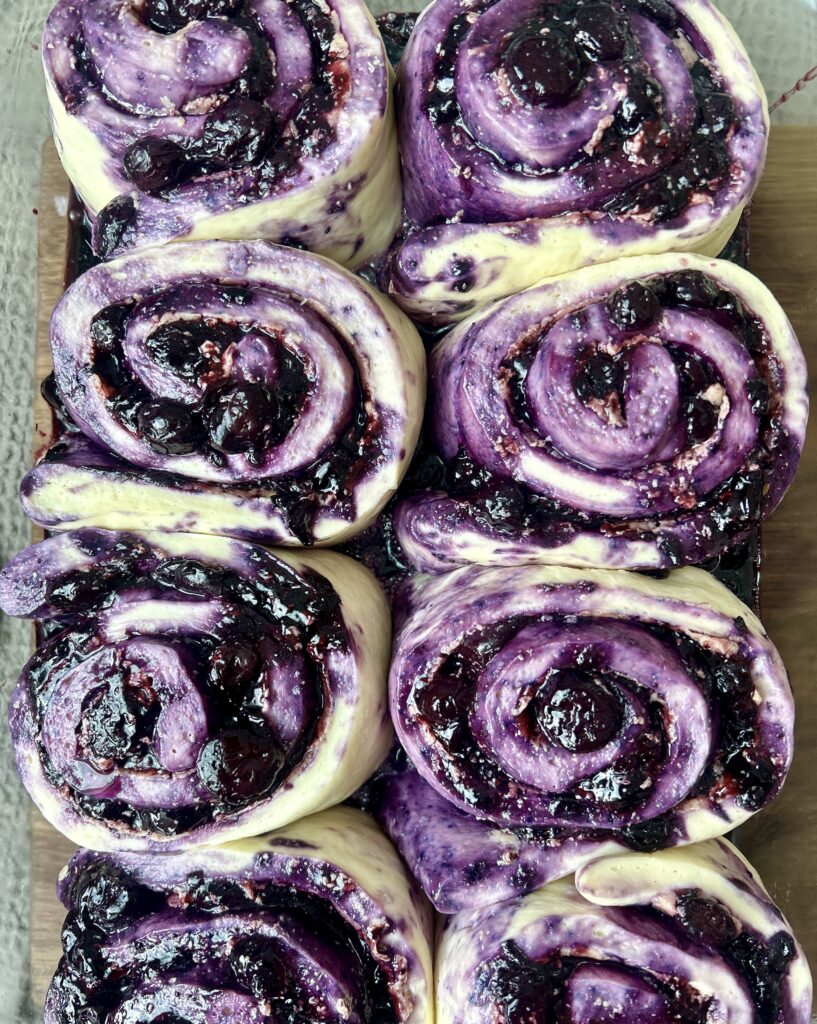 a pan of unbaked blueberry cinnamon buns