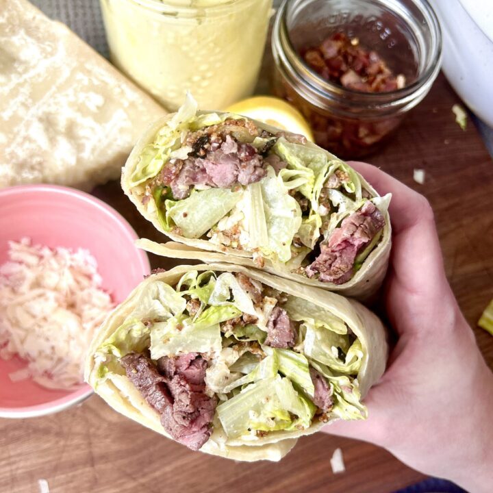 a warp with steak caesar salad inside