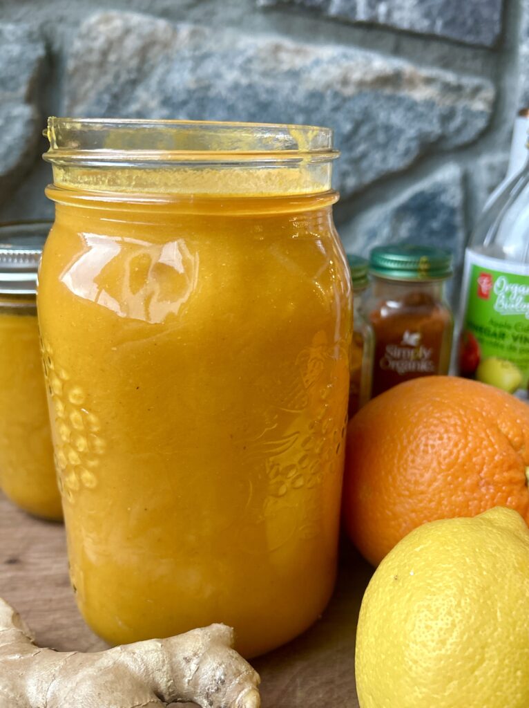 a large jar of ginger, turmeric, orange and lemon juice