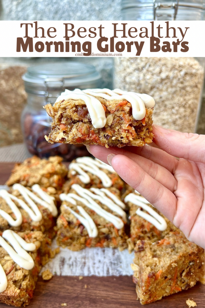 a wood board with carrot and apple oatmeal bars topped with cream cheese glaze