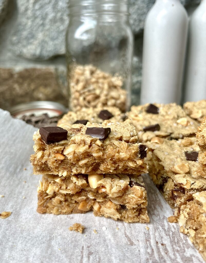 peanut butter bars with chocolate chunks stacked