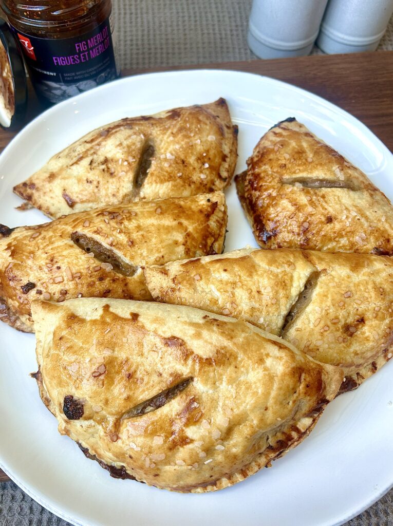 a white plate full of golden savoury meat pies