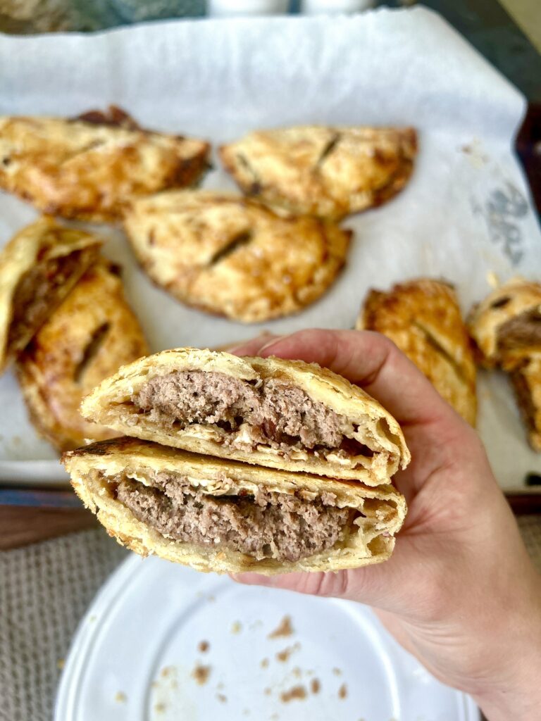 a meat hand pie broken in half