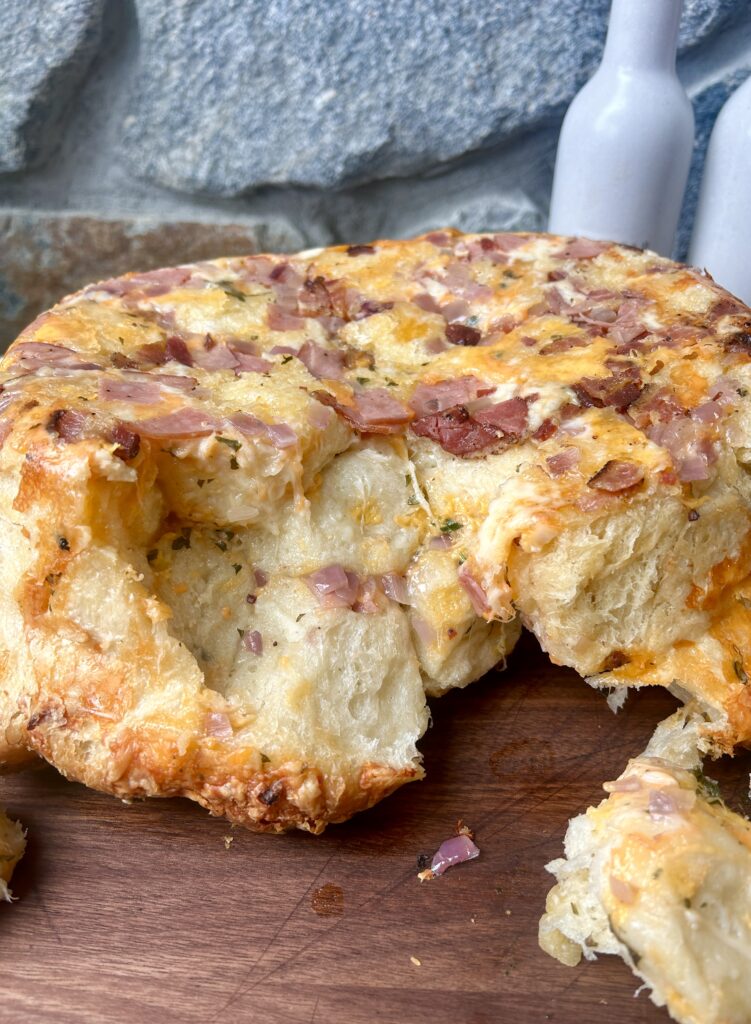 ham and cheese pull apart bread on a wood board