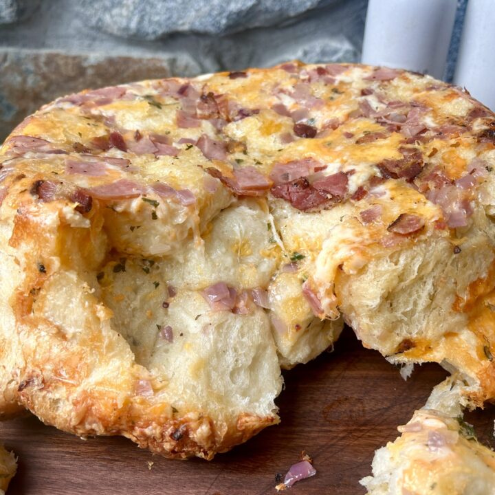 ham and cheese pull apart bread on a wood board