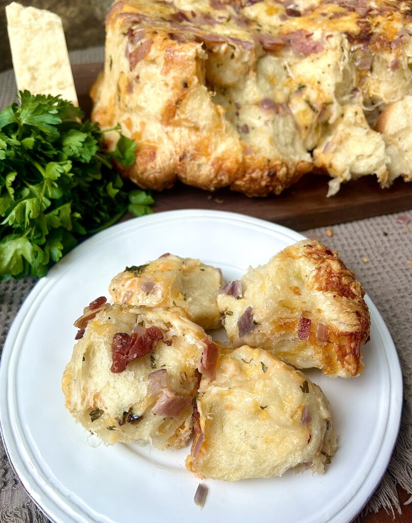 a white plate with mini ham and cheese buns