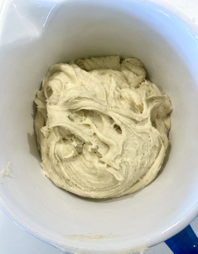 a white bowl of bread dough