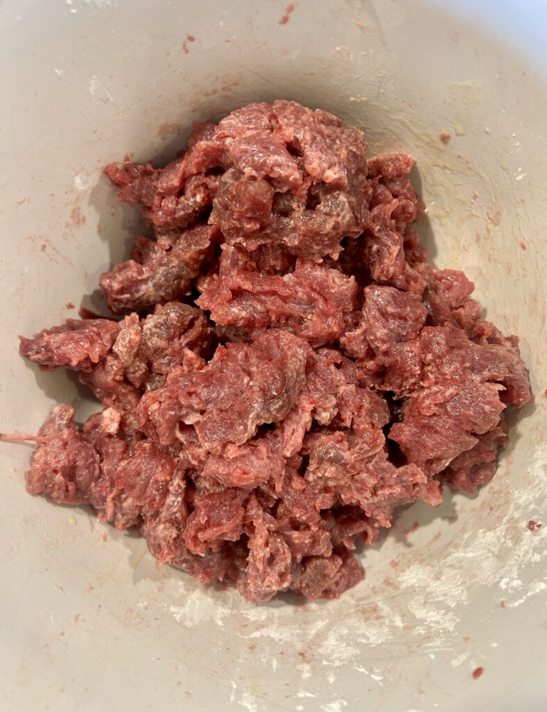 a bowl of uncooked venison meat