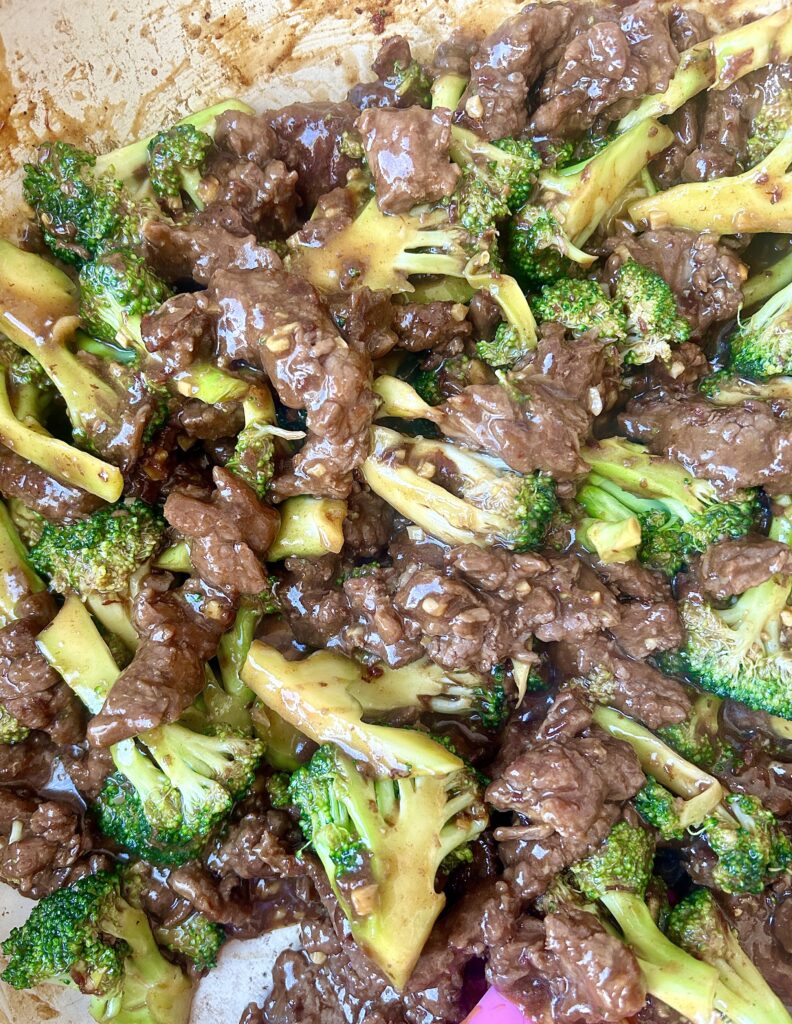 strips of venison and broccoli in a skillet 
