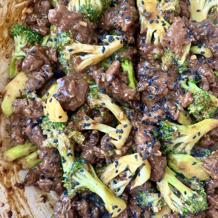 strips of venison steak with broccoli and soy sauce in a skillet