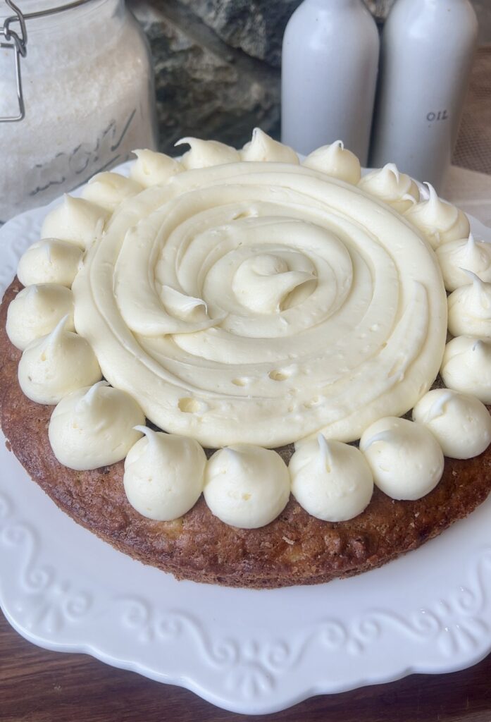 a layer of cake wth icing dollops on top