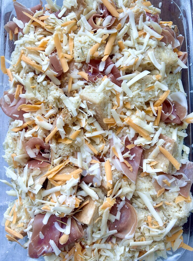 a sourdough casserole with shredded cheese and prosciutto 