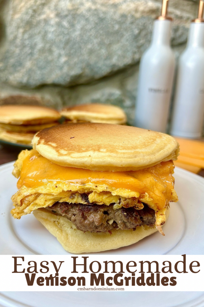 a white plate with a pancake and sausage breakfast sandwich
