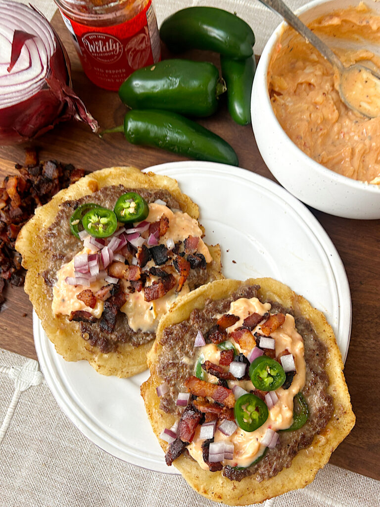 a white plate with 2 jalapeño popper tacos