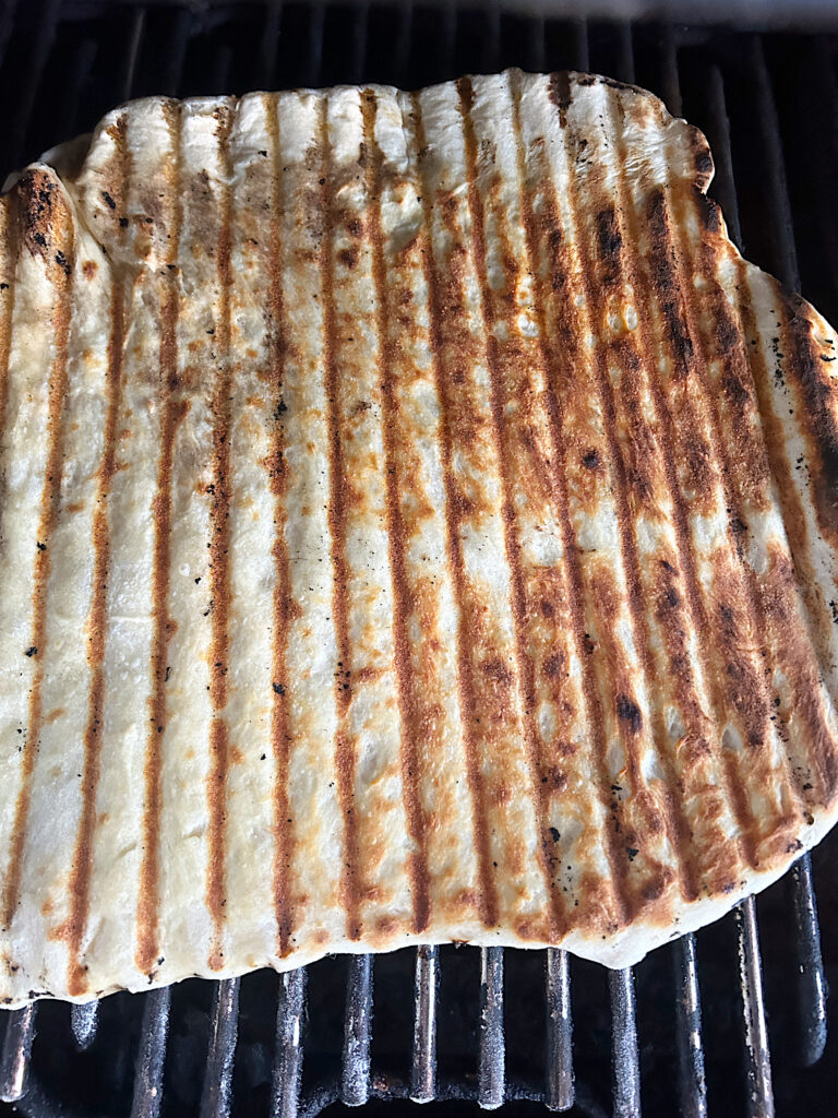 flatbread dough being grilled