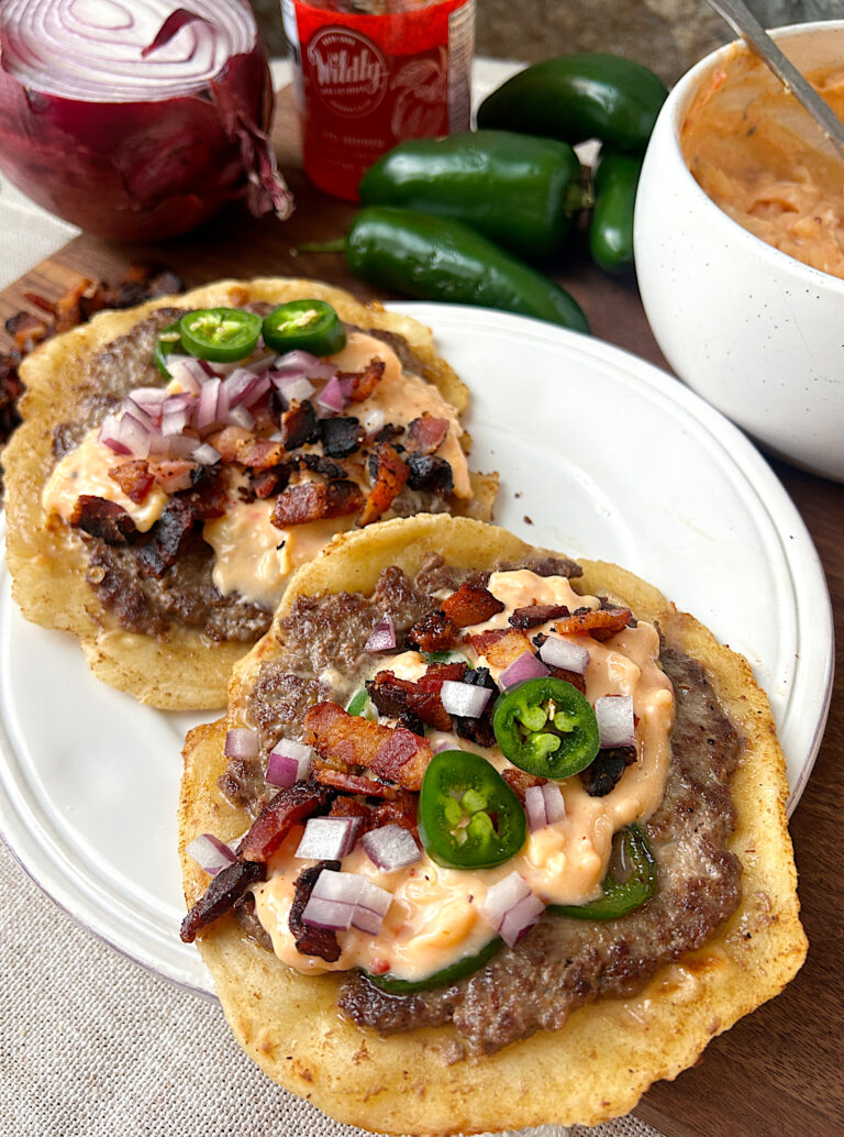 a white plate with two jalapeno popper tacos