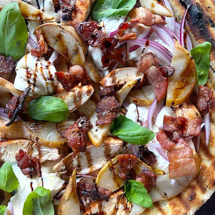 a flatbread with pear, burrata cheese, bacon and basil
