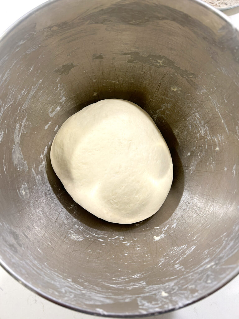 a stainless bowl of dough