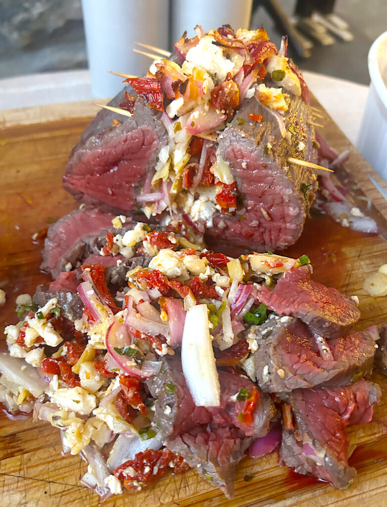 a venison roast, stuffed with greek filling, sliced thin