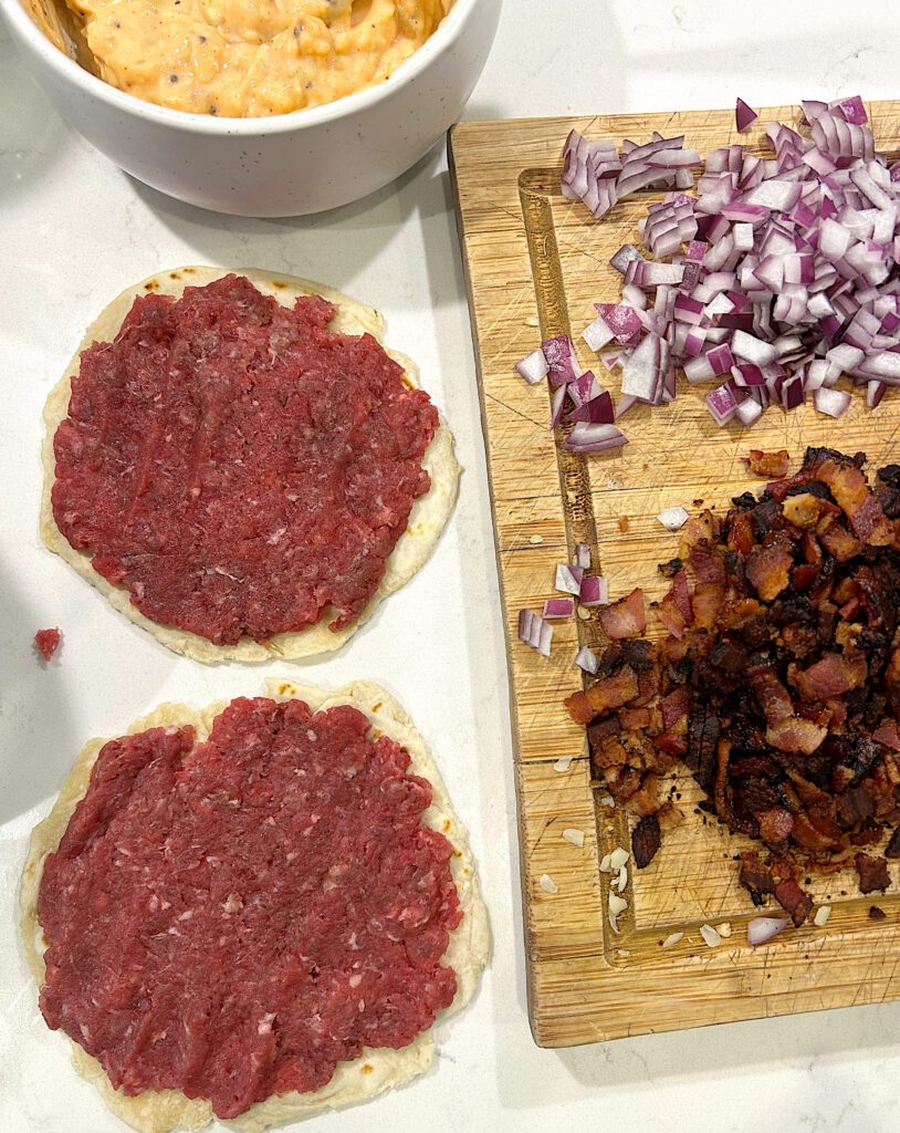uncooked ground meat on tortillas