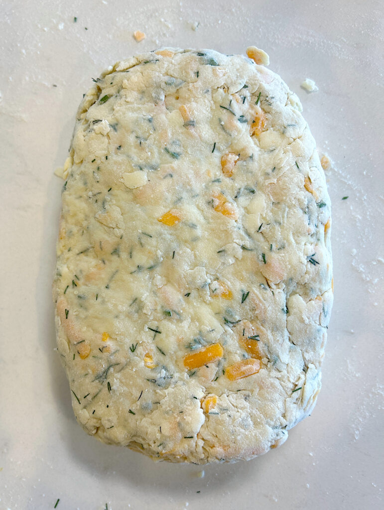 a rectangle of biscuit dough on a white counter