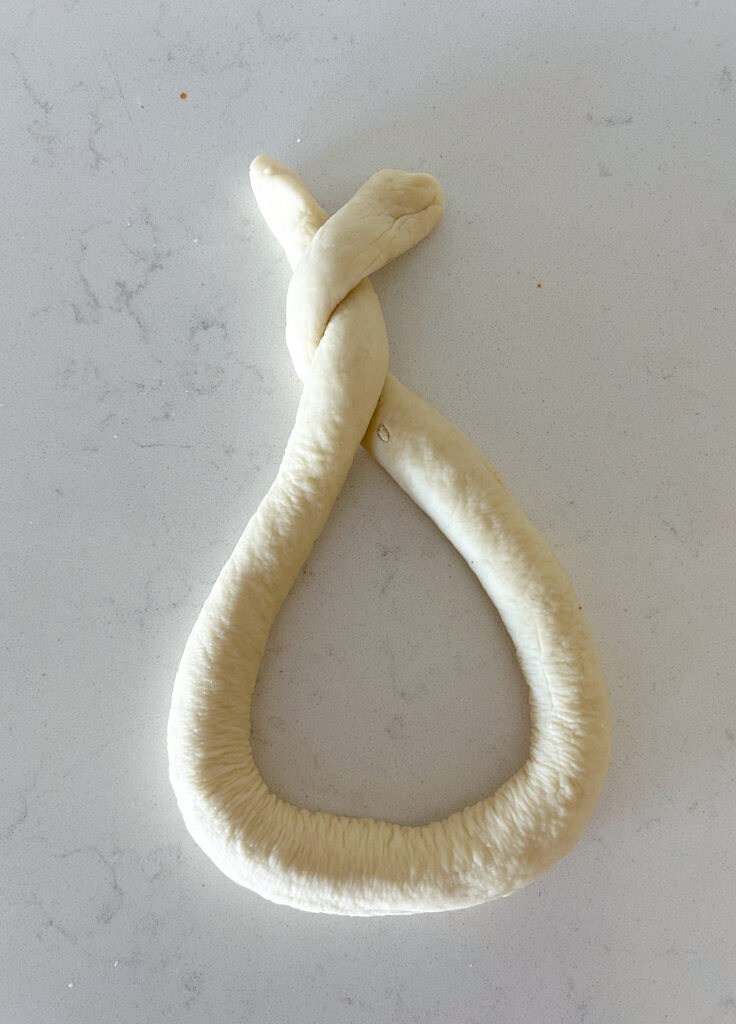 soft pretzel dough being twisted