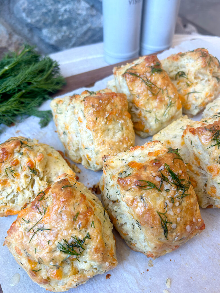 a tray of biscuits with cheese and dill